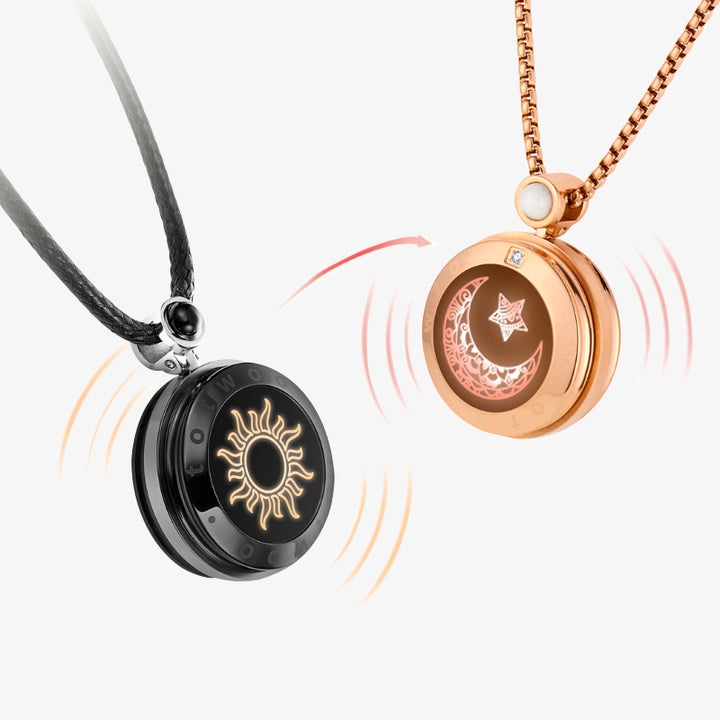 Two round pendant necklaces shown on a light gray background: one black with a gold sun design on a black cord, and one rose gold with a moon and star design on a rose gold chain. Red curved lines suggest a transformation between the two states.