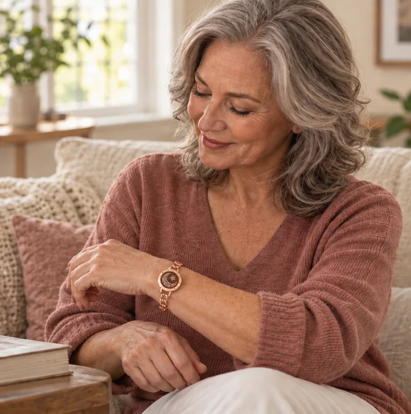 The mother at home looks down at the rose gold Moon Figaro bracelet on her wrist